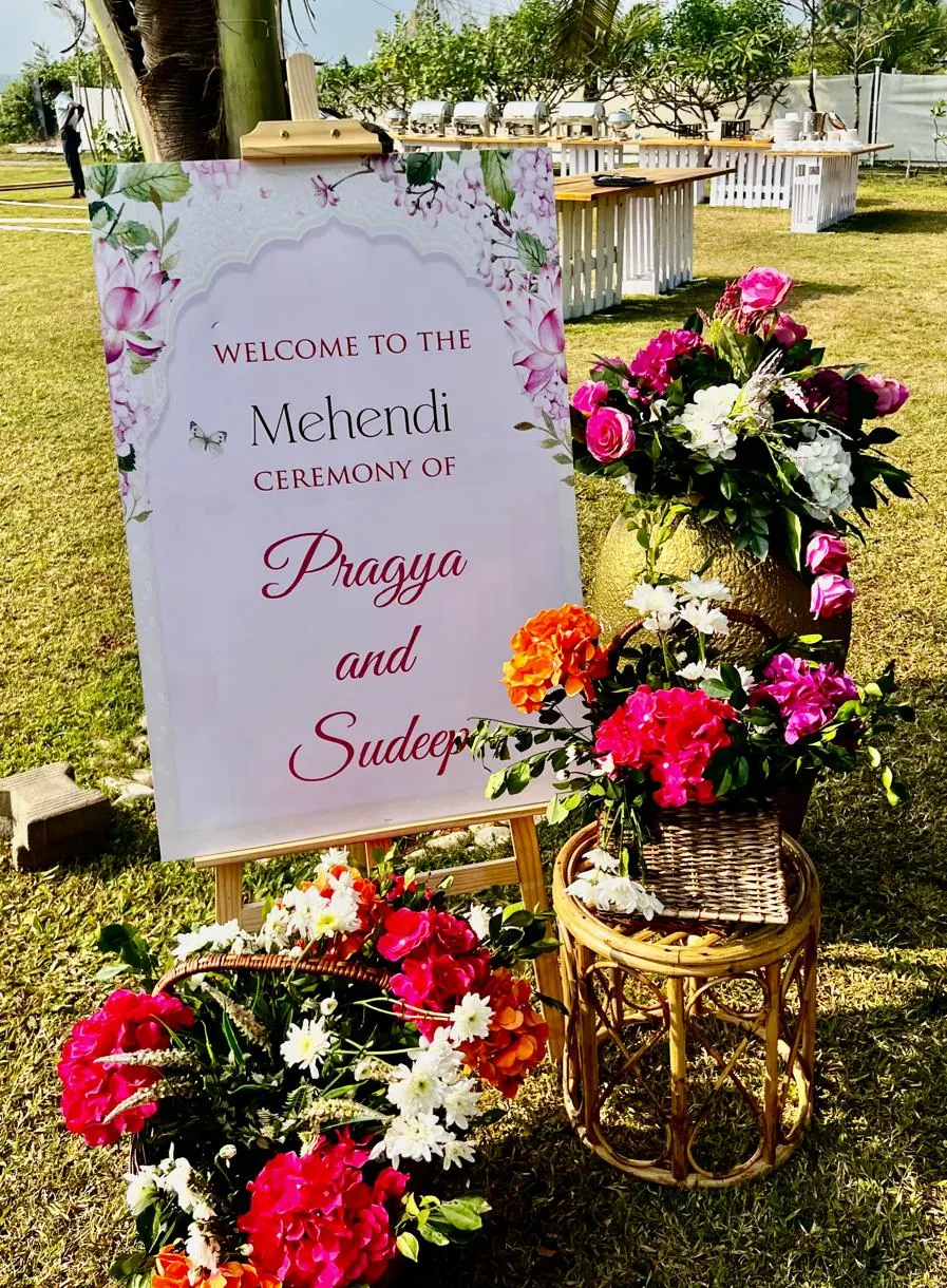 Welcome to the Mehendi ceremony floral signage with pink hydrangeas and roses at a Goa lawn event by Imagine Decorators