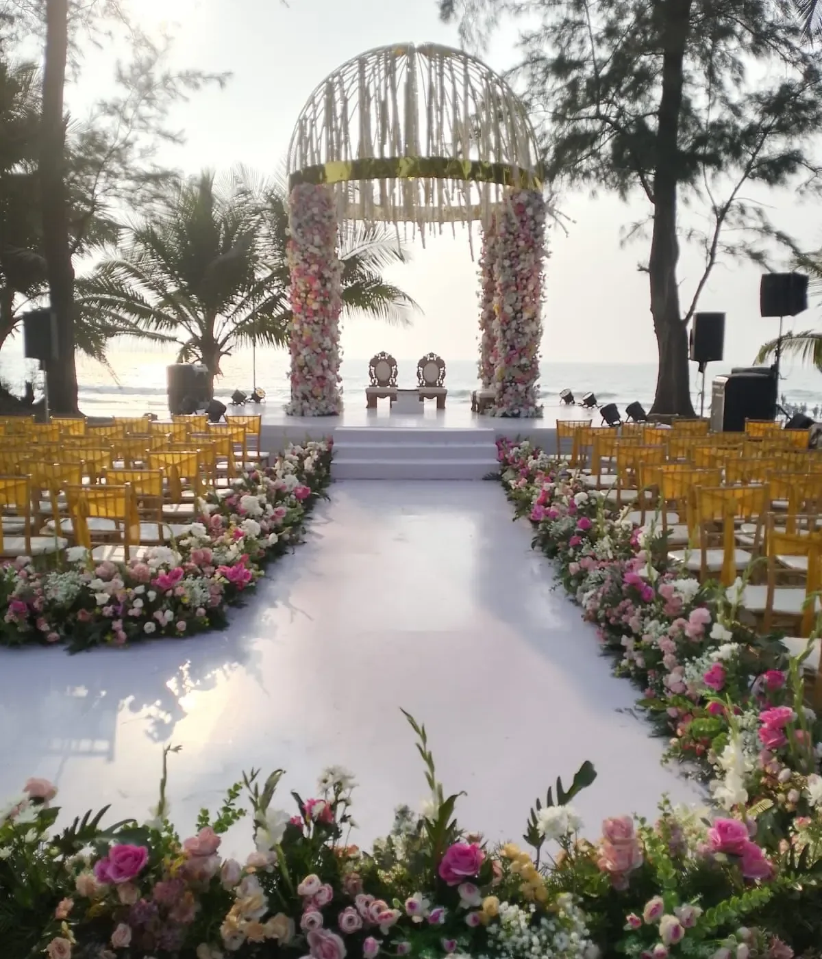 Beachfront wedding mandap with golden chiavari chairs and a floral aisle by the Arabian Sea, Imagine Decorators Goa